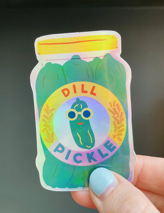 Naomi Wilkinson holographic dill pickle jar sticker with a pickle in sunglasses, held in a hand