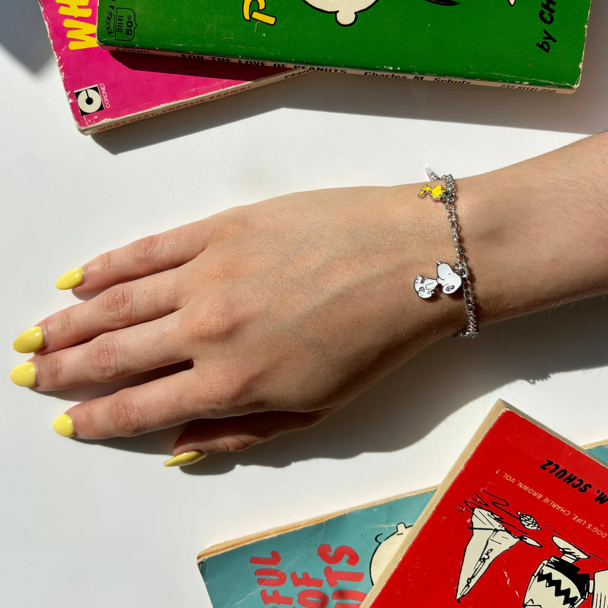 Snoopy charm bracelet worn on a wrist