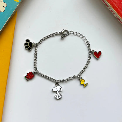 Snoopy charm bracelet with a doghouse, heart, paw print, Snoopy and Woodstock charms