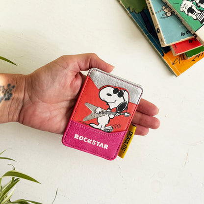 Hand holding the Peanuts Rockstar card holder