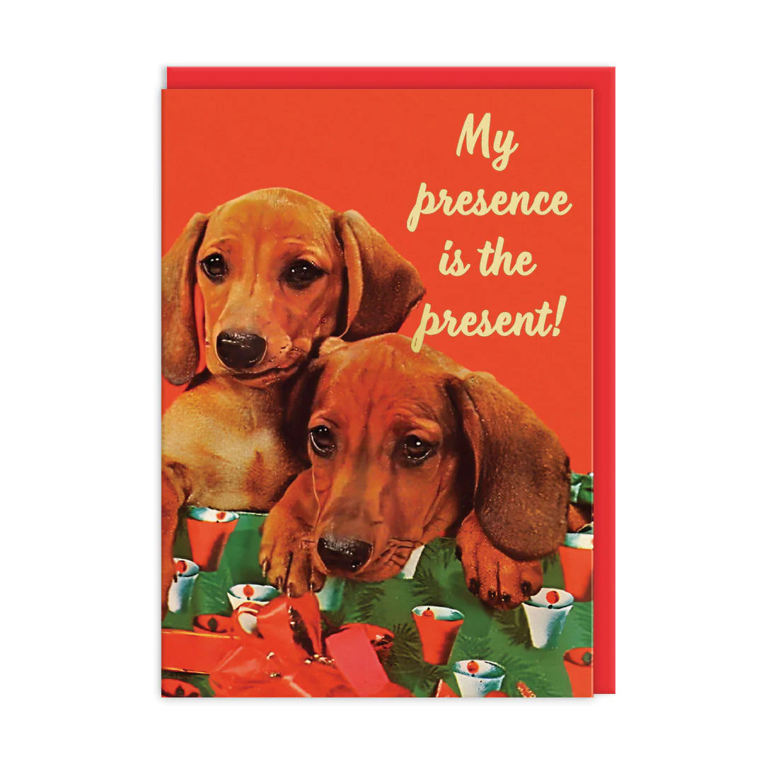 Ohh Deer card: two dachshund puppies among Christmas presents, with 'My presence is the present!'