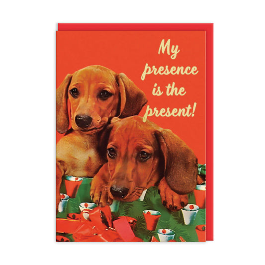 Ohh Deer card: two dachshund puppies among Christmas presents, with 'My presence is the present!'