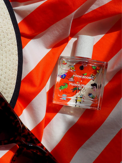 Poom Poom perfume on a red and white striped towel