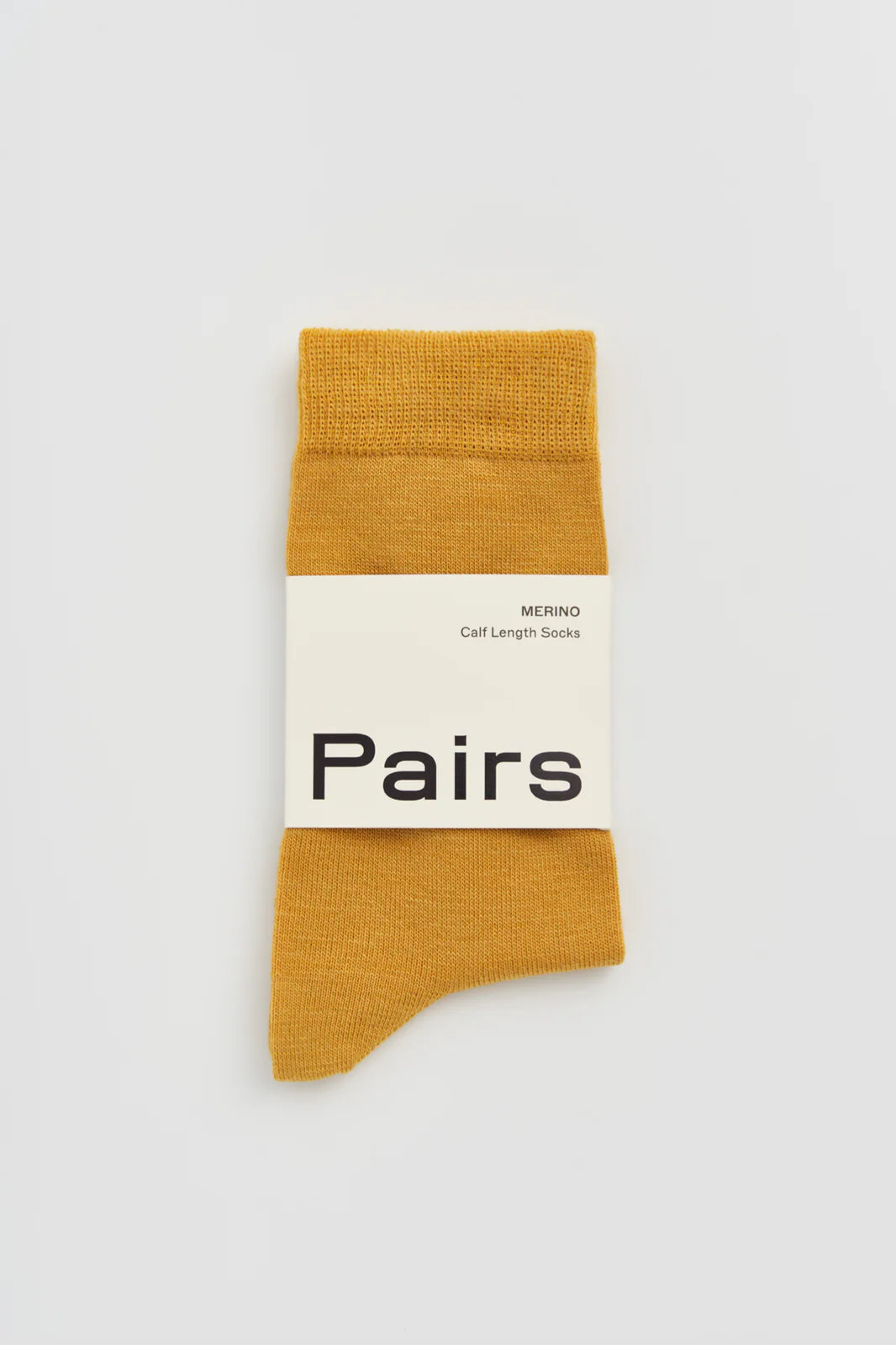 Pairs merino calf-length socks in golden yellow, with a Pairs paper band
