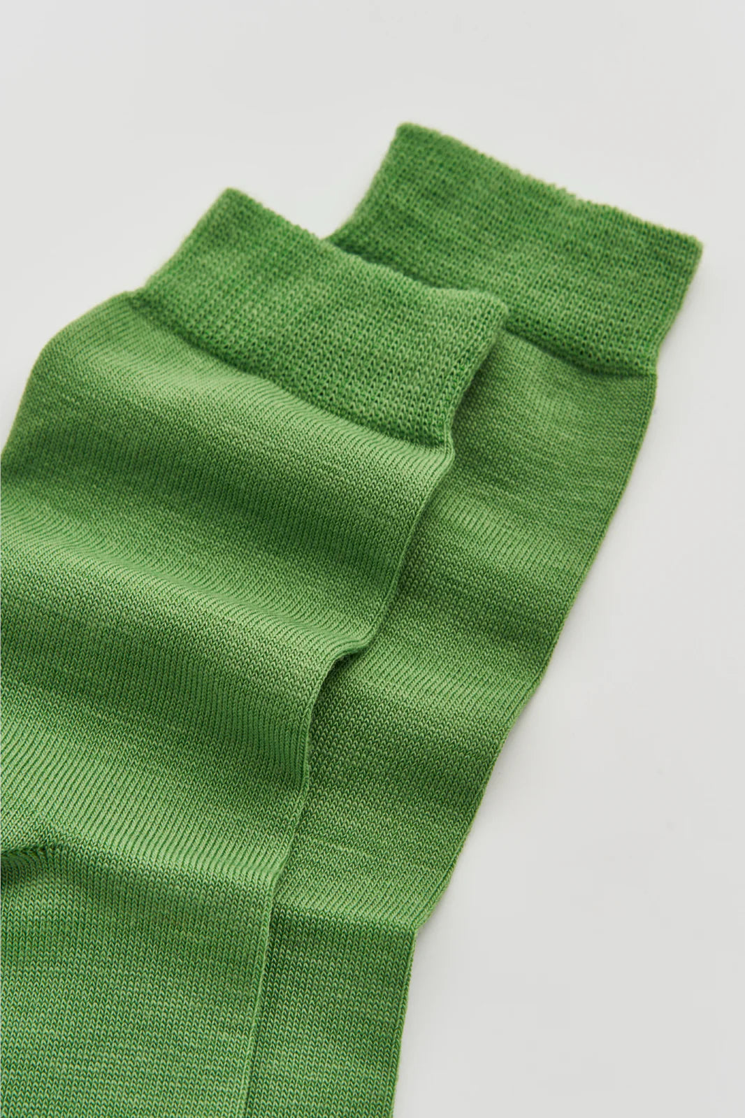 Close-up of the smooth grass green merino knit