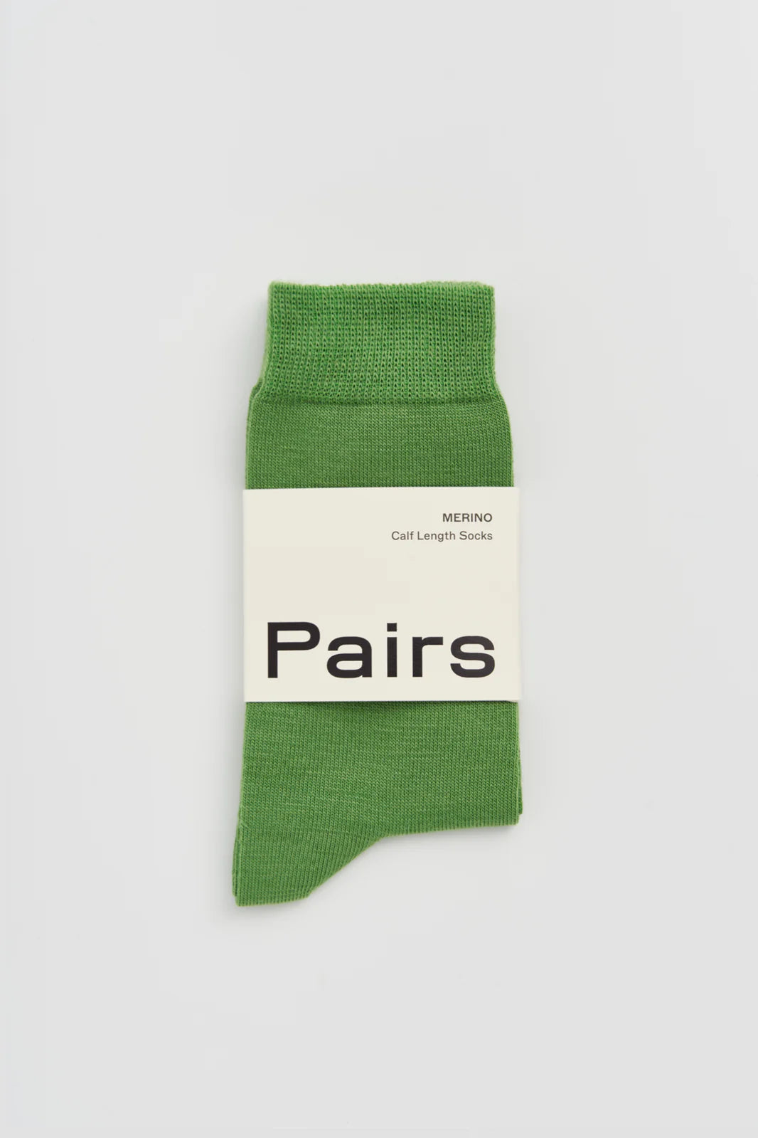 Pairs merino calf-length socks in grass green, with a Pairs paper band