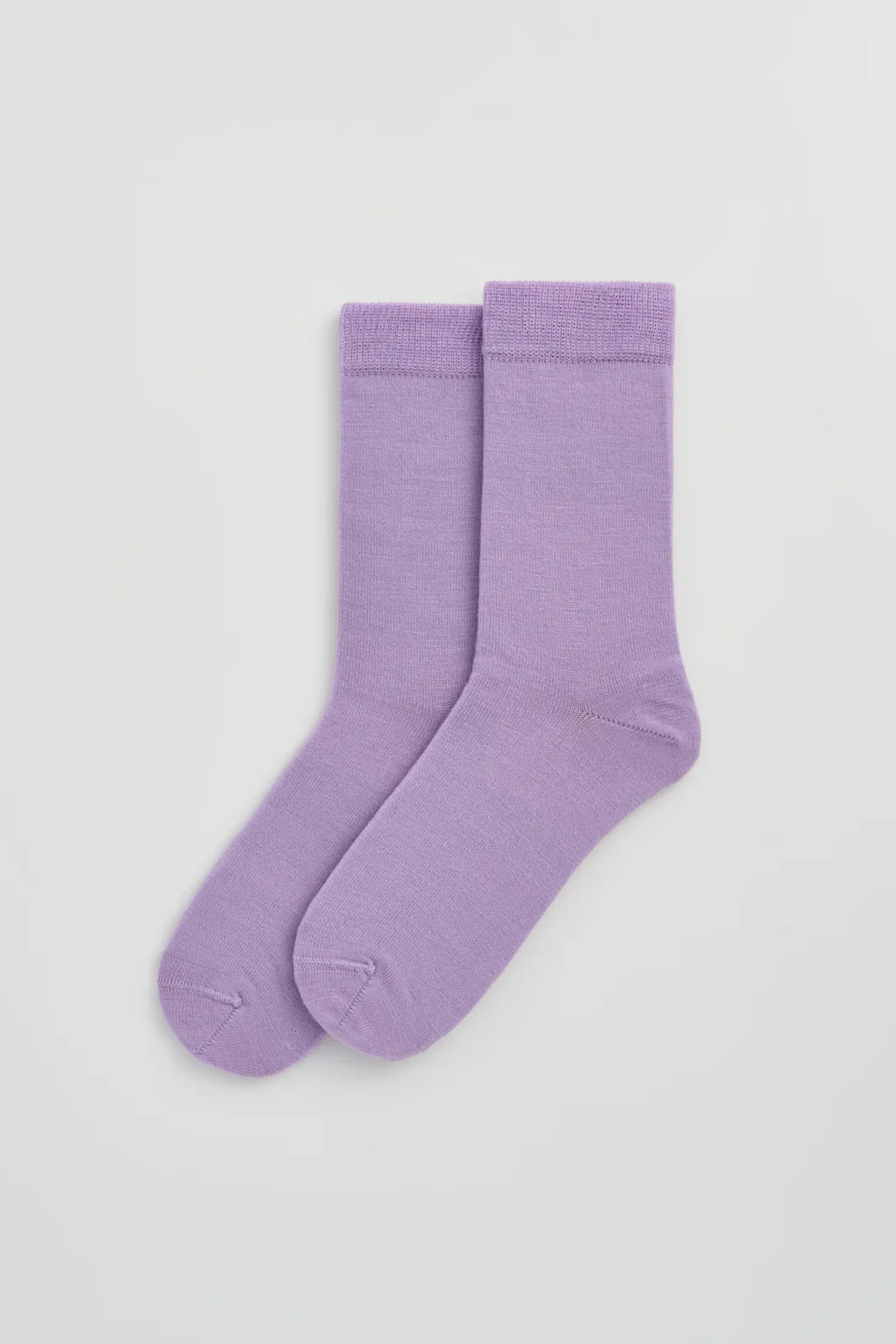 Pair of palma violet calf-length merino socks laid flat