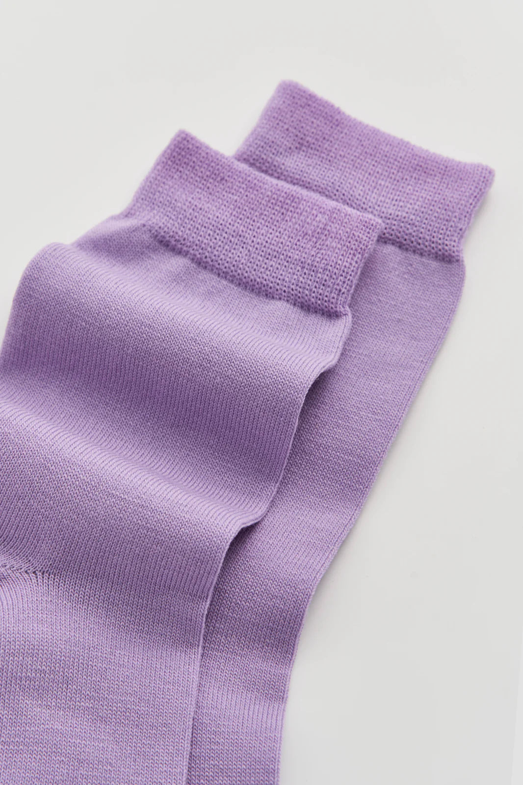 Close-up of the smooth violet merino knit