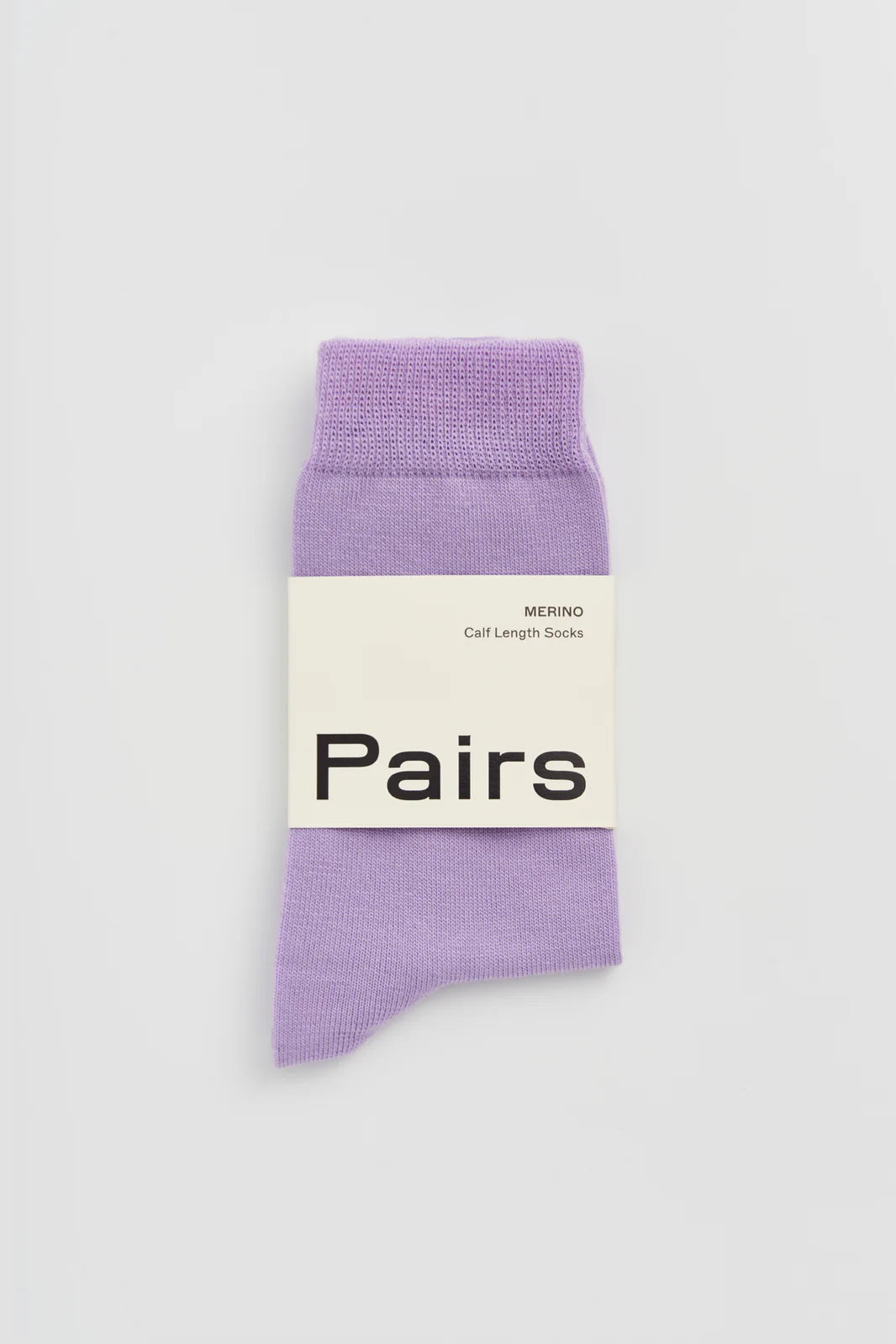 Pairs merino calf-length socks in palma violet, with a Pairs paper band