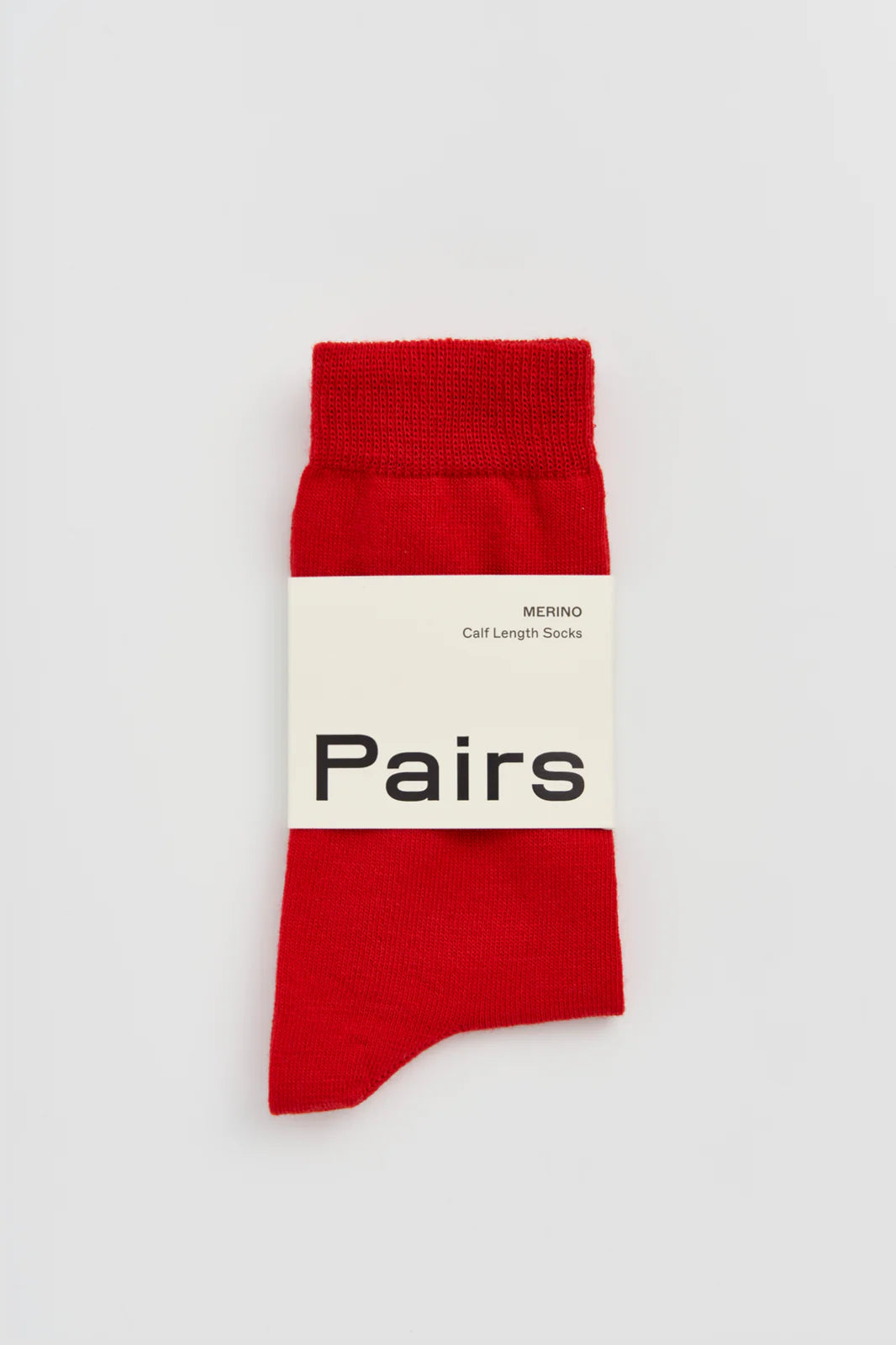Pairs merino calf-length socks in red, with a Pairs paper band