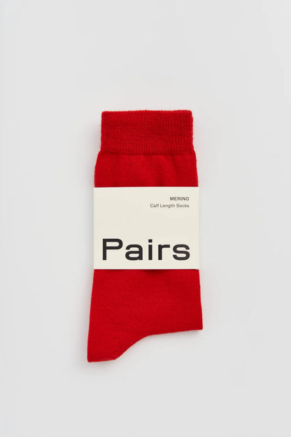 Pairs merino calf-length socks in red, with a Pairs paper band
