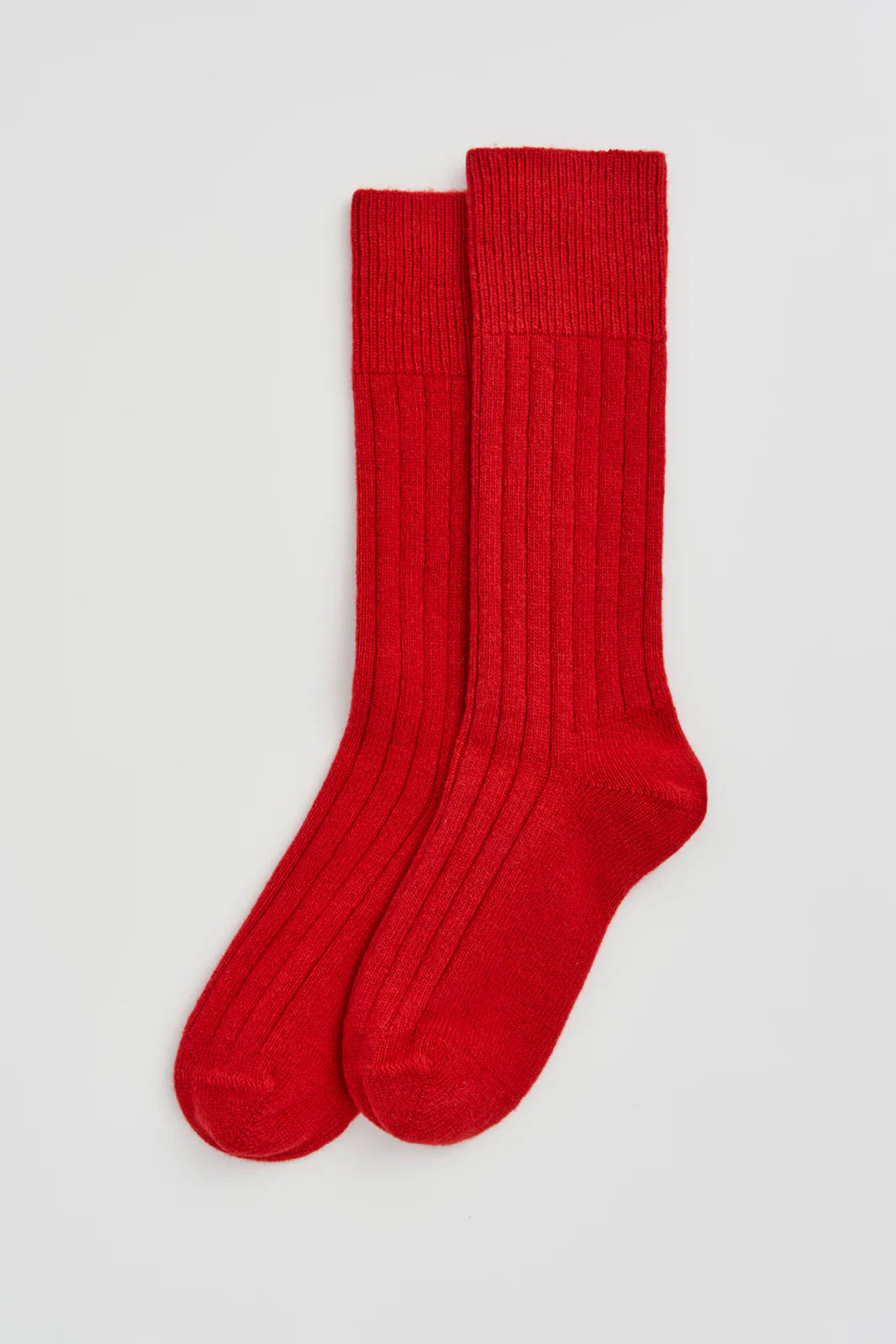 Pair of red ribbed merino bed socks laid flat