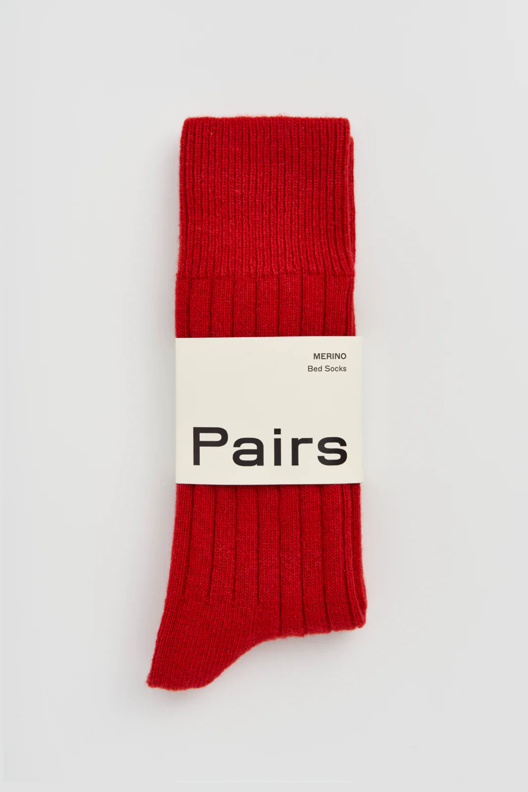 Pairs merino bed socks in postbox red, ribbed, with a Pairs paper band