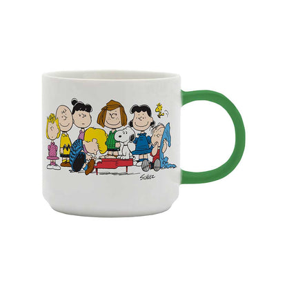 White mug with a green handle and the Peanuts gang