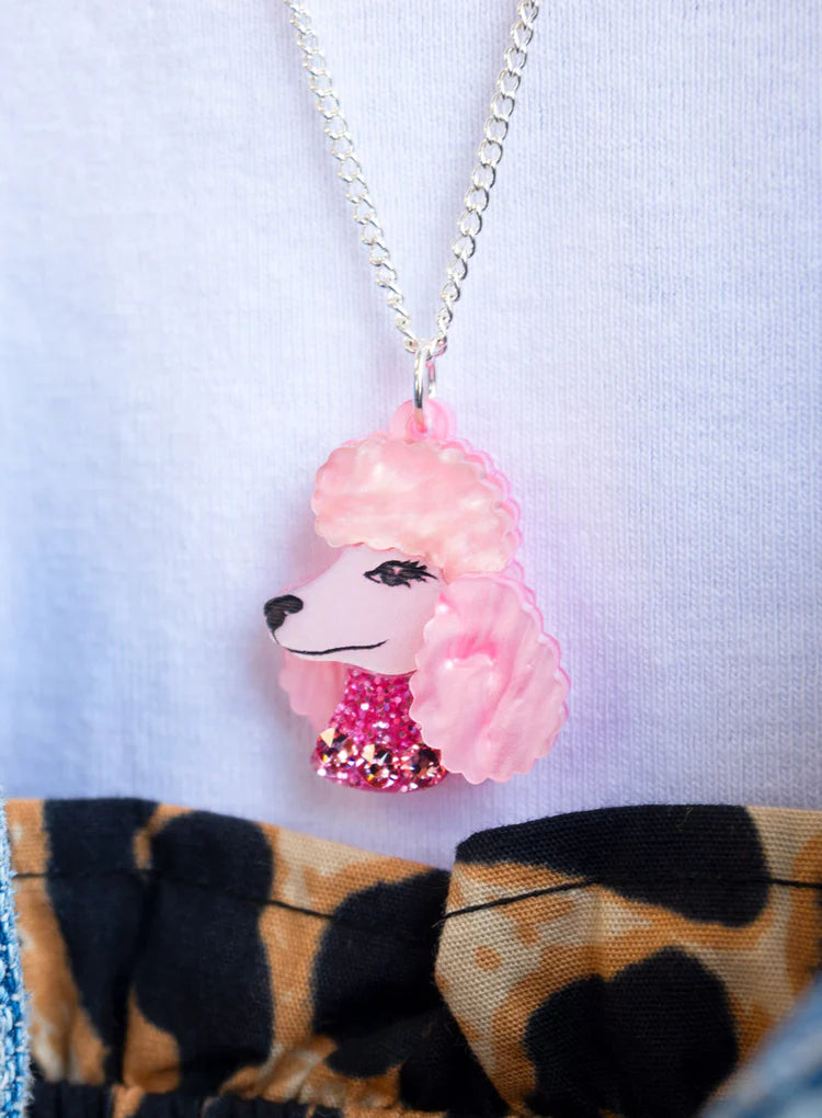 Pink poodle pendant worn with a leopard print top