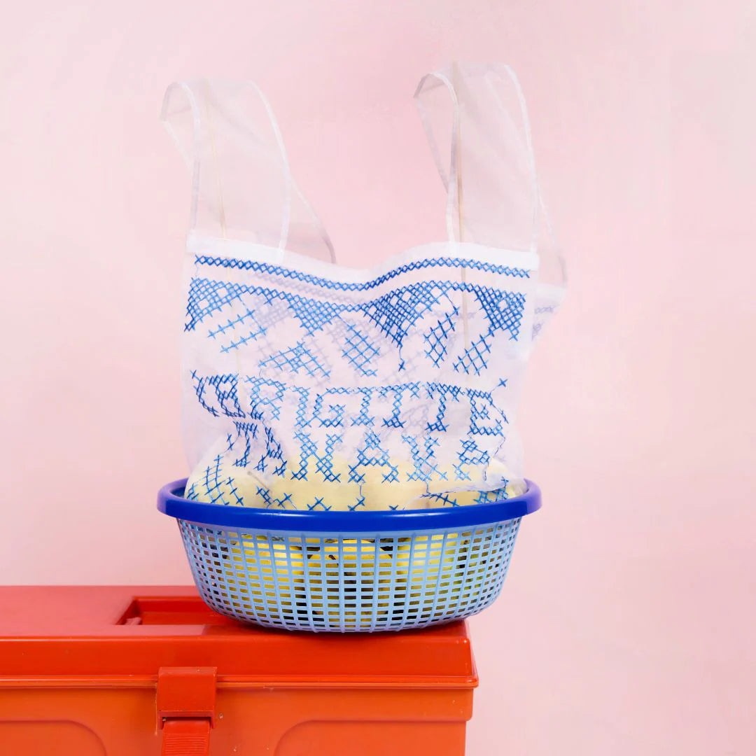 Organza bag holding a blue basket on a red toolbox