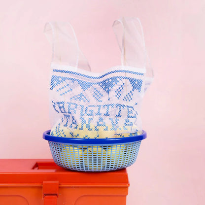 Organza bag holding a blue basket on a red toolbox
