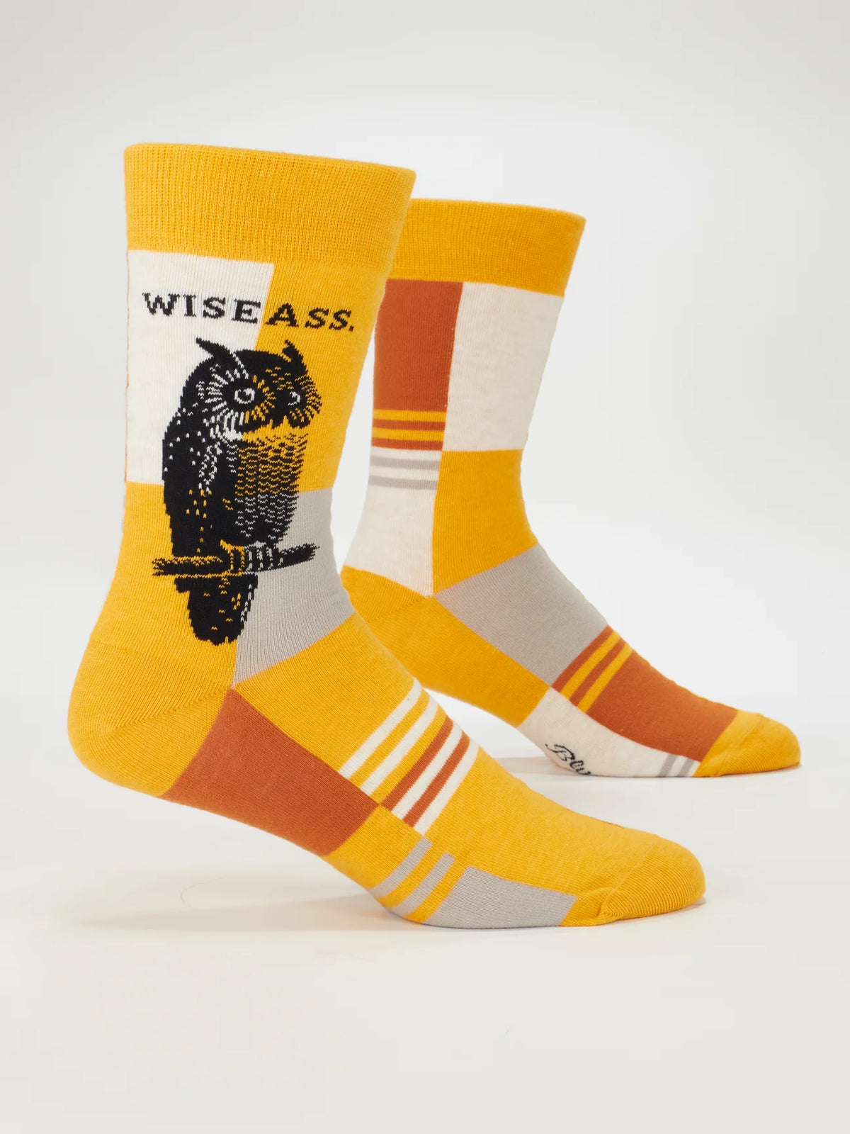 Blue Q yellow socks with an owl and 'Wise ass', on leg forms
