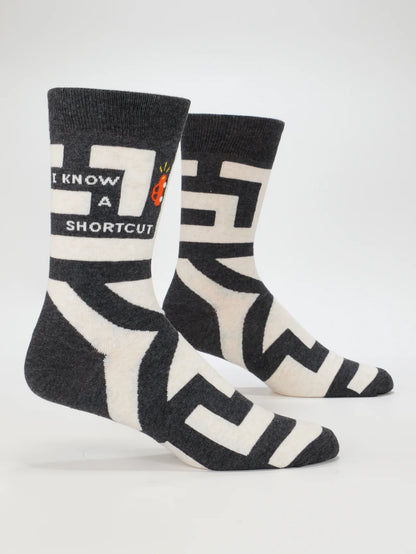 Blue Q socks in charcoal and cream with a maze pattern and 'I know a shortcut', on leg forms