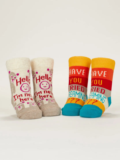 Both pairs of baby socks standing upright