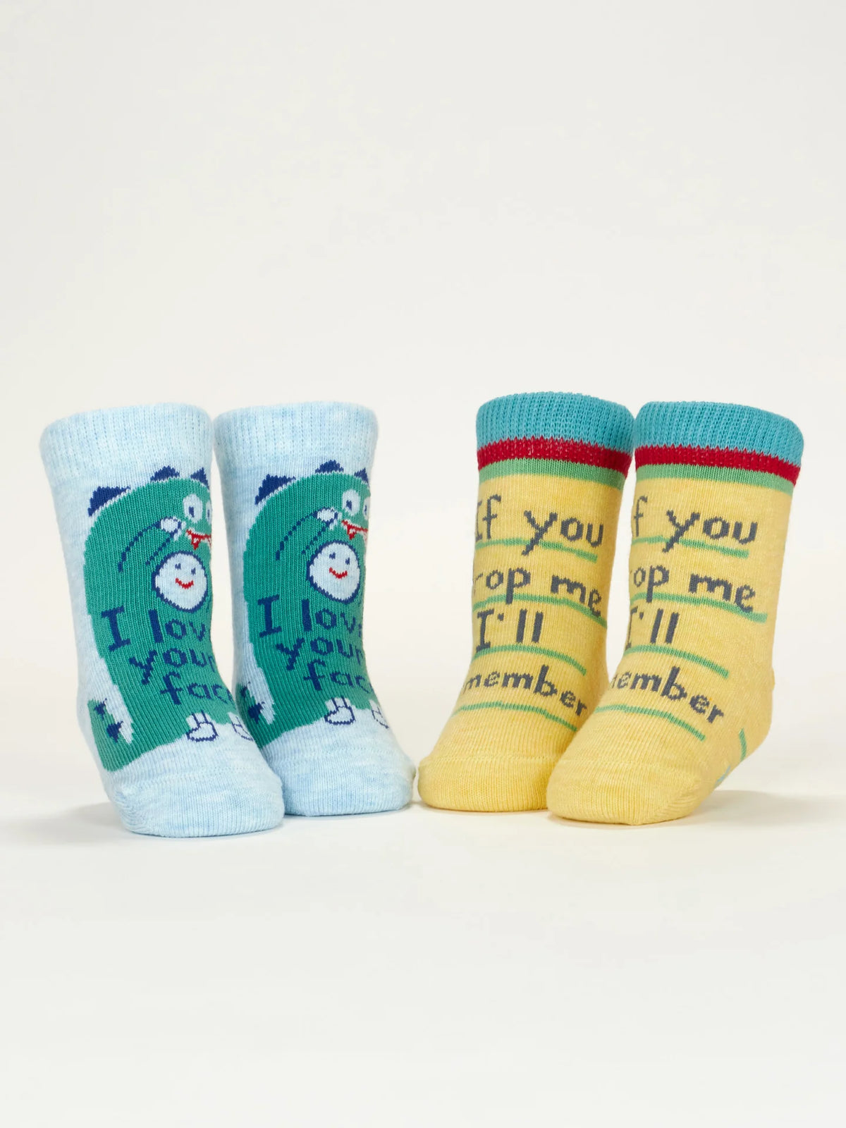 Baby socks standing up, blue dinosaur pair and yellow pair