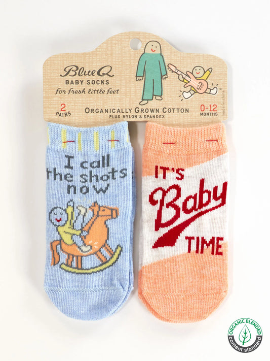 Two pairs of baby socks in packaging: I call the shots now, and It's baby time