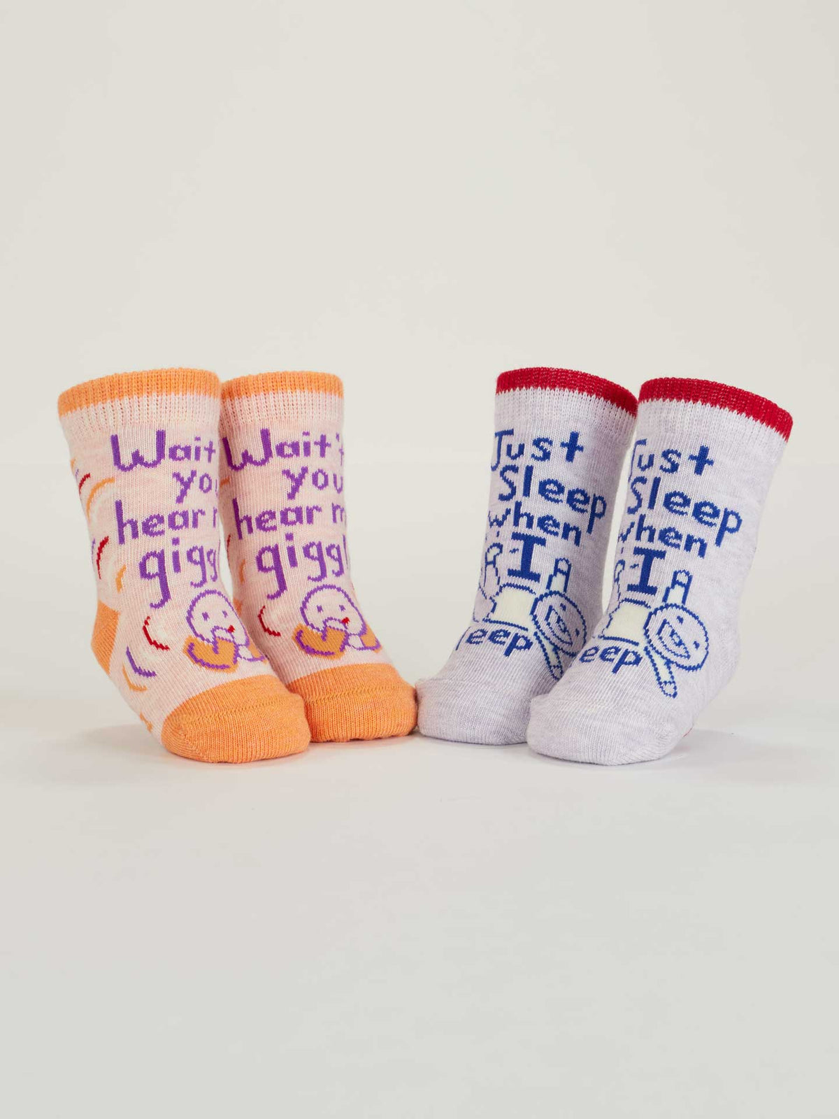 Both pairs of baby socks standing upright