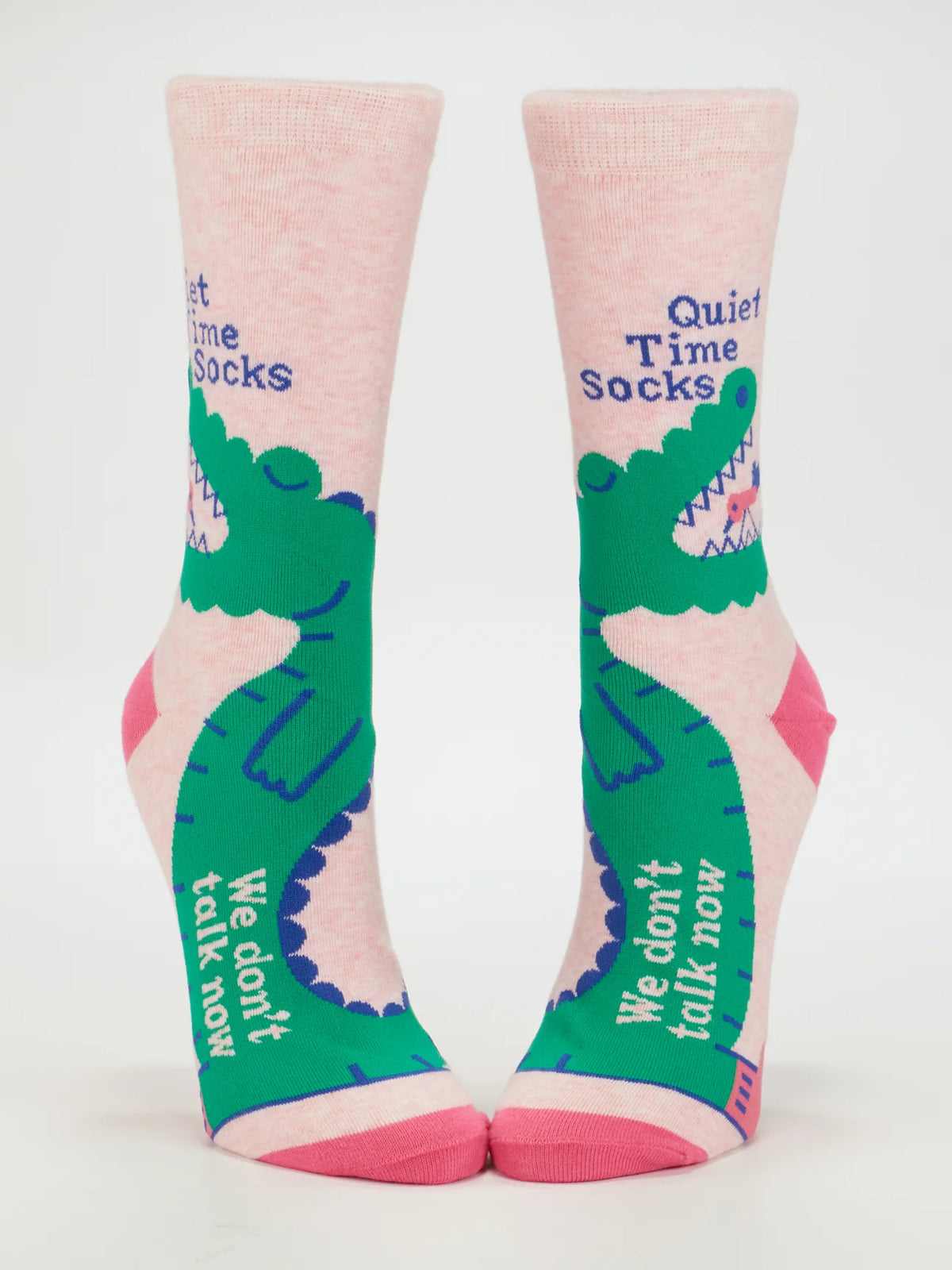 Blue Q Quiet Time socks: pink with a green crocodile, reading 'Quiet time socks' and 'We don't talk now', shown on leg forms
