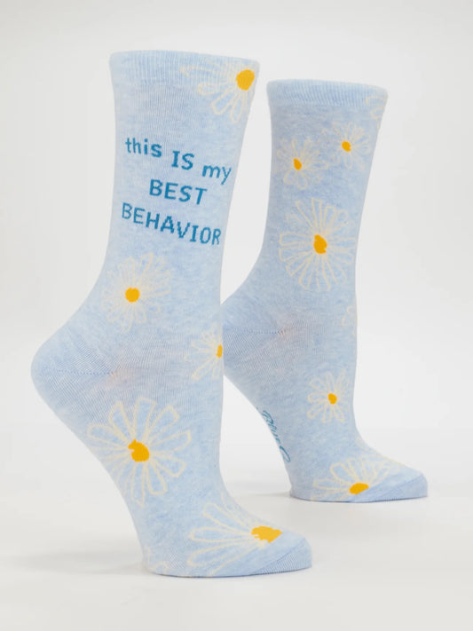 Blue Q socks: pale blue with white daisies and the words 'This is my best behavior', shown on leg forms