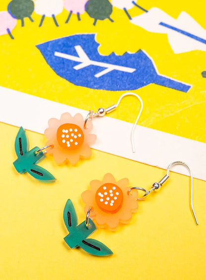 Flower earrings on a yellow and blue print