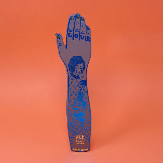 Blue leather tattooed arm bookmark on an orange background