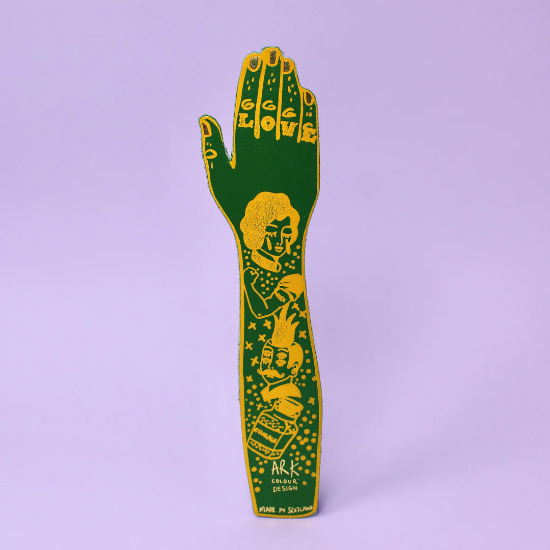 Green leather tattooed arm bookmark on a lilac background