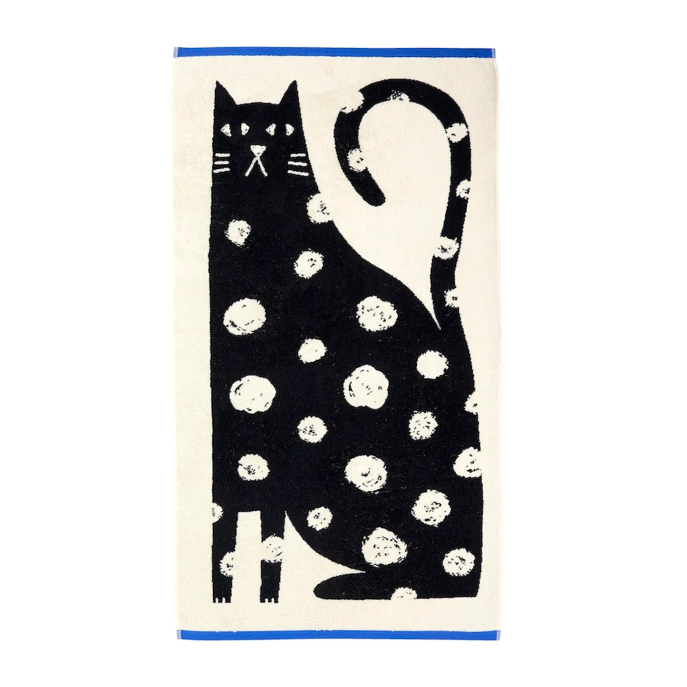 Donna Wilson Lazy Cat bath towel: a black spotted cat on cream