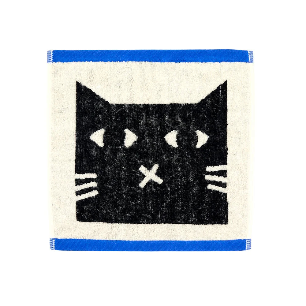 Cream face cloth with a black cat face and blue edges