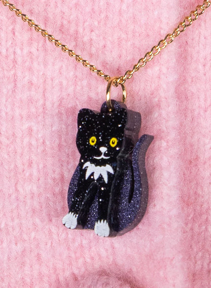 Toy cat pendant on a pink knit