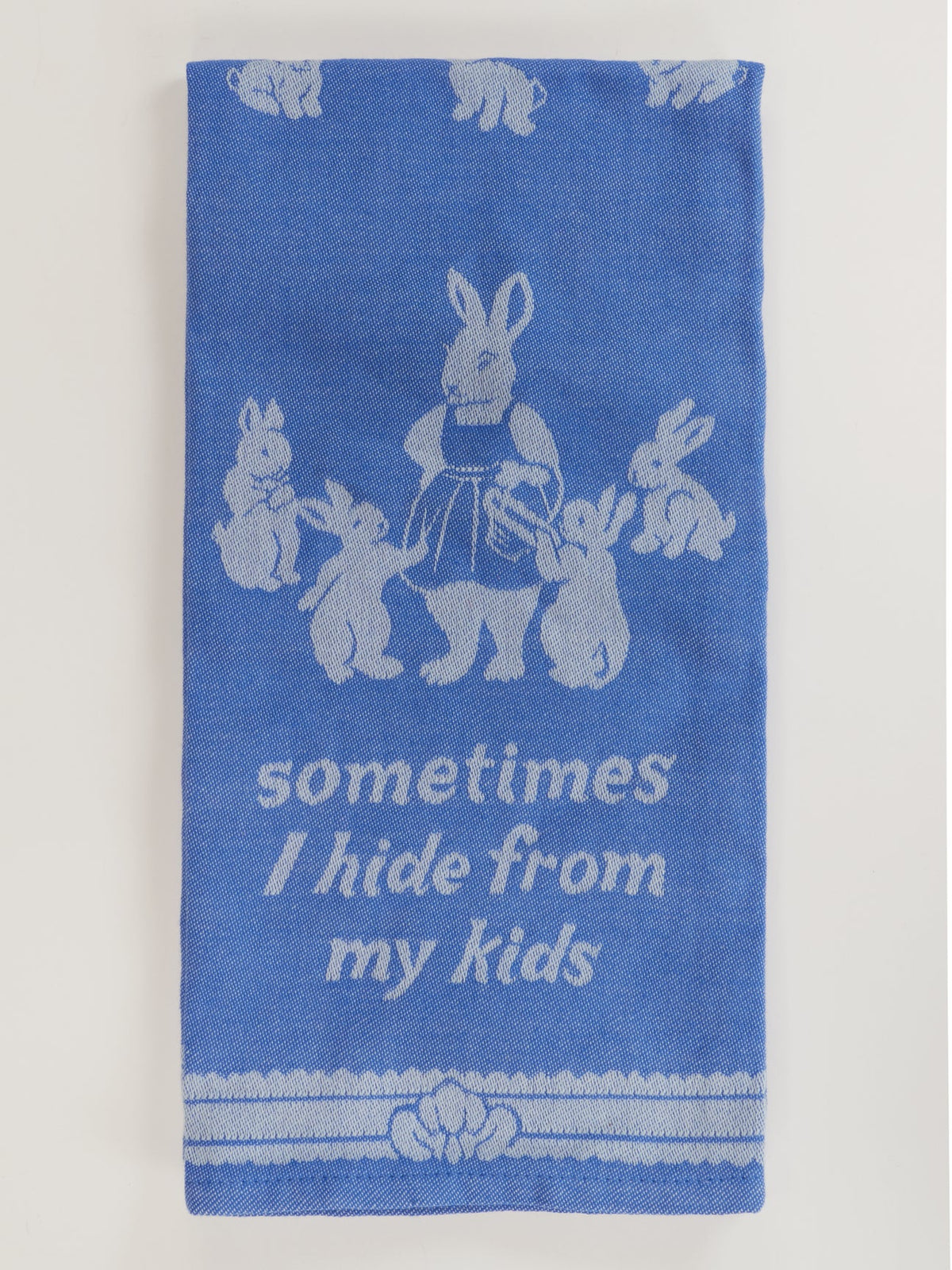 Blue Q tea towel, folded: blue rabbits and 'Sometimes I hide from my kids'