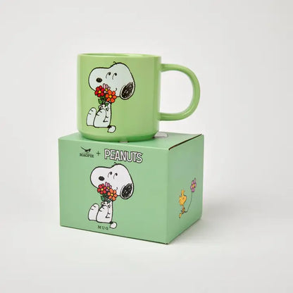Peanuts Posy mug sitting on its green gift box