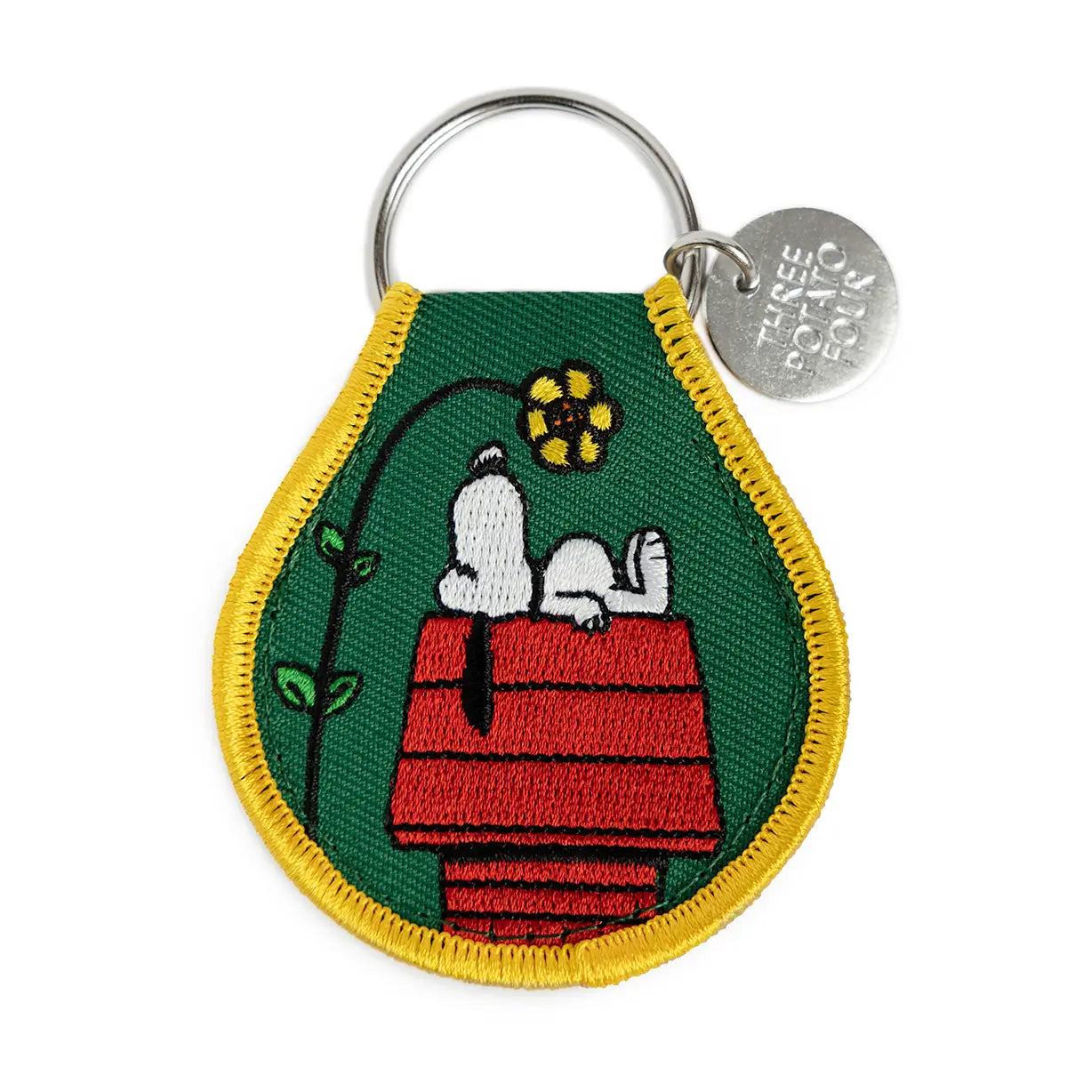 Embroidered Snoopy key ring patch: Snoopy asleep on his red doghouse beside a flower, on green