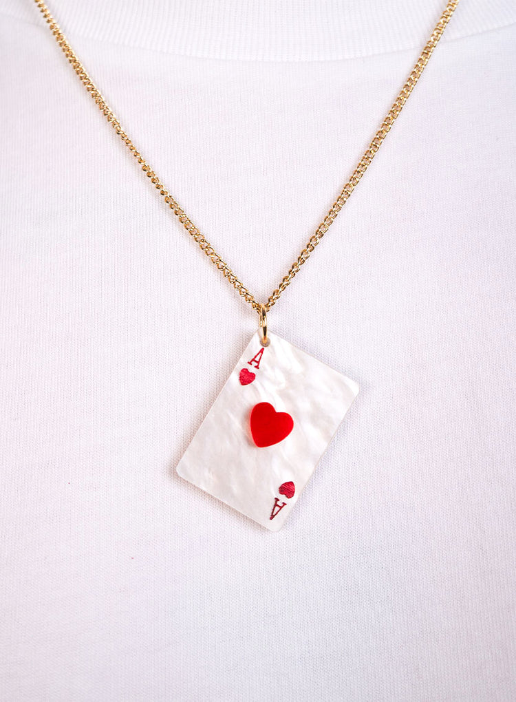 Ace of hearts pendant worn with a white top