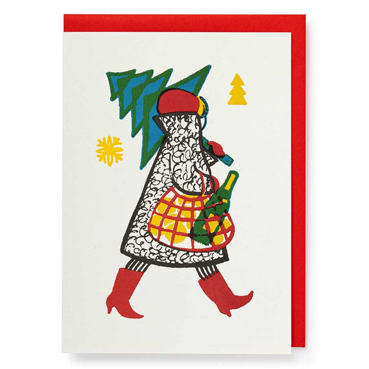 Card of a woman in red boots carrying a Christmas tree and a bottle