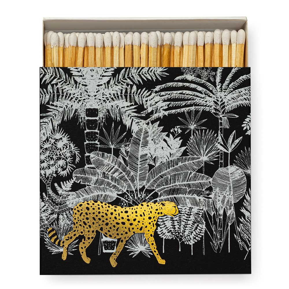 Square matchbox with a cheetah prowling through a black and white jungle