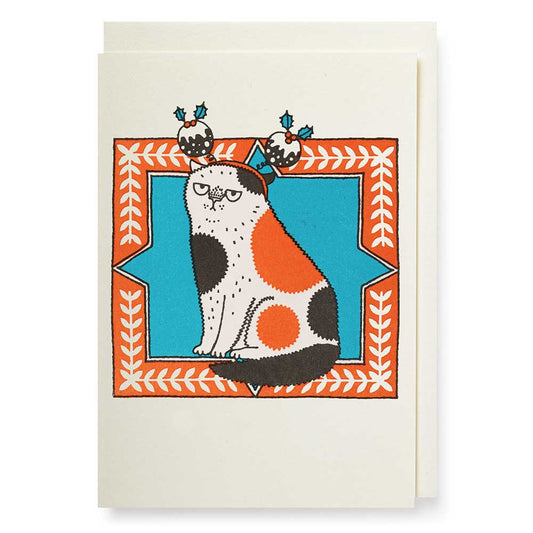 Small card with a grumpy spotted cat wearing Christmas puddings on its head