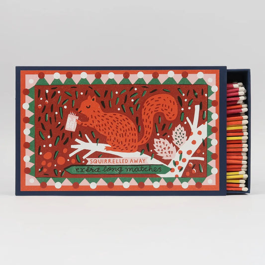 Giant matchbox with a red squirrel among leaves and berries: Squirrelled away