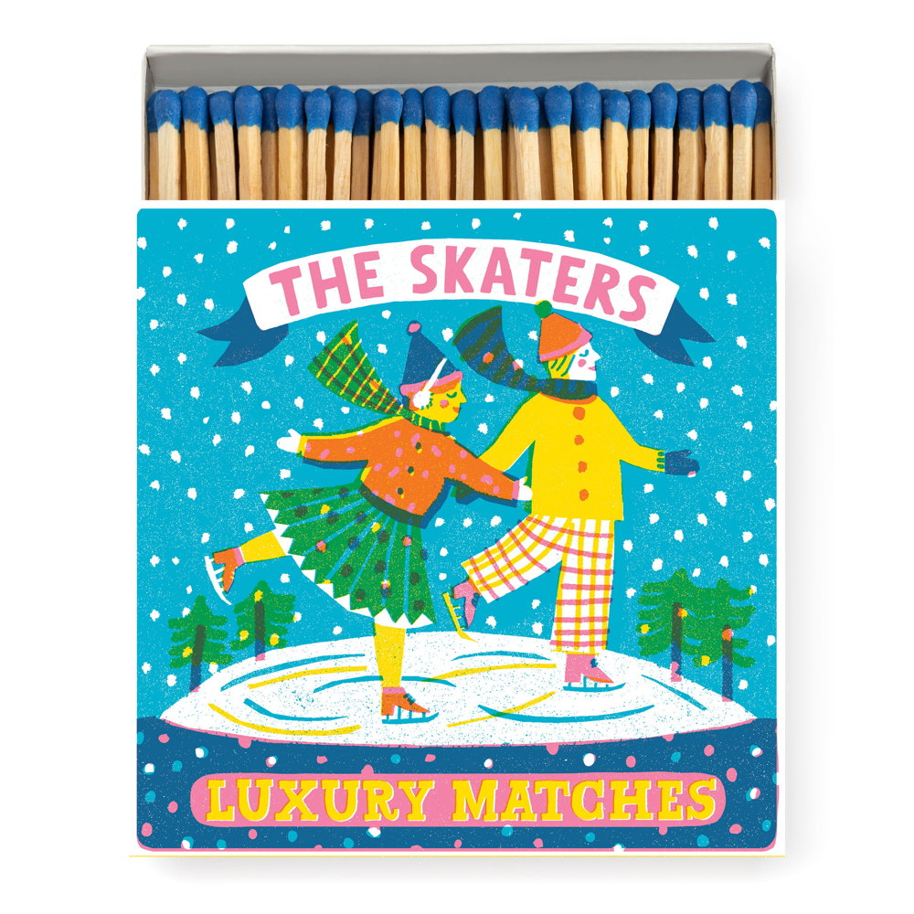 Square box of luxury matches with two ice skaters under falling snow: The Skaters