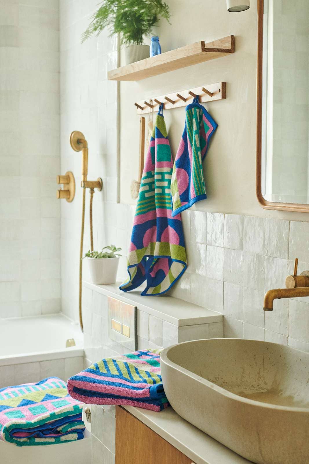 Circus towels in a bathroom beside a stone basin