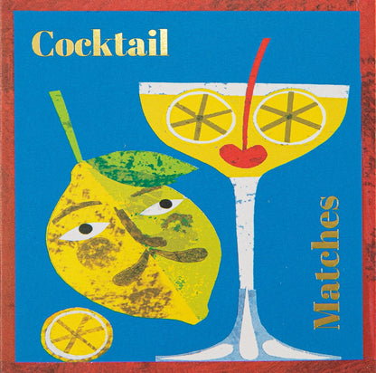 Archivist Cocktail matchbox: a lemon with a face beside a cocktail glass with lemon slices and a cherry, on blue