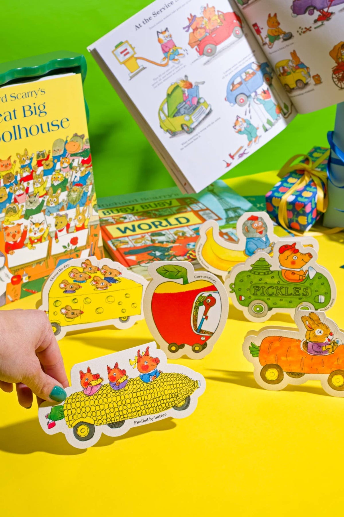 Richard Scarry die-cut car cards, including Cheese The Day, standing on a yellow table