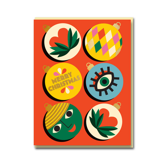 1973 Christmas card: six round baubles with patterns, faces and 'Merry Christmas' on orange
