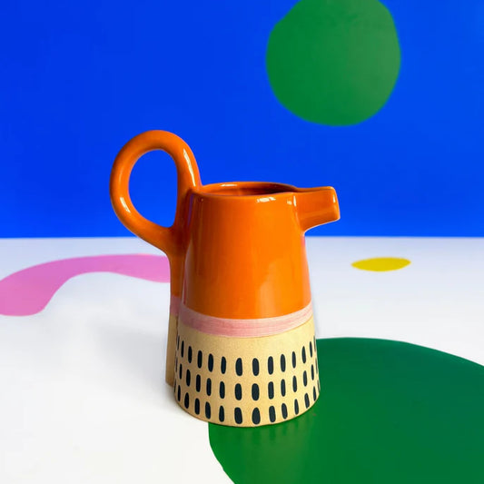 Bloc orange glazed jug with a cream base patterned with black dots
