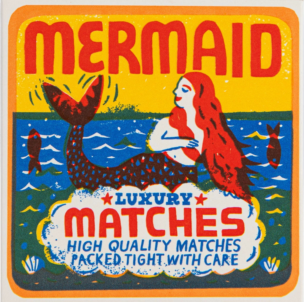 Archivist Mermaid matchbox: a red-haired mermaid on the waves, with 'Luxury matches – high quality matches packed tight with care'